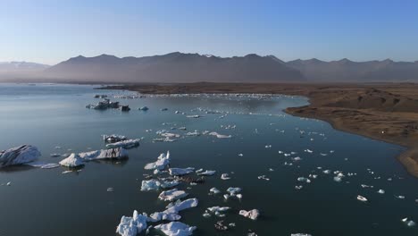 experience the breathtaking beauty of jökulsárlón’s glaciers from above, as our drone captures the stunning contrasts of icy blues and rugged landscapes in iceland’s magnificent wilderness.