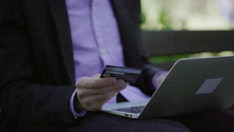 cropped shot of businessman making online purchases from laptop