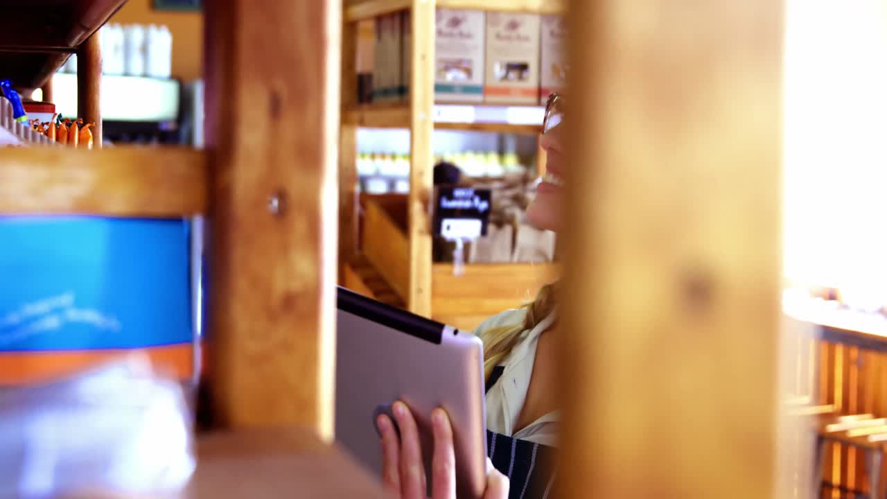 슈퍼마켓에서 디지털 태블릿을 사용하는 여성 직원