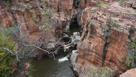 waterfalls flowing over the geological formation at bourke's luck potholes, south africa