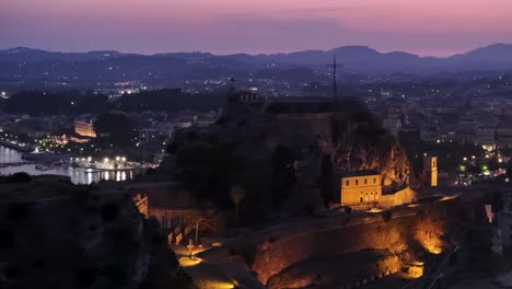 night aerial close-up view over corfu old fortress and lighthouse