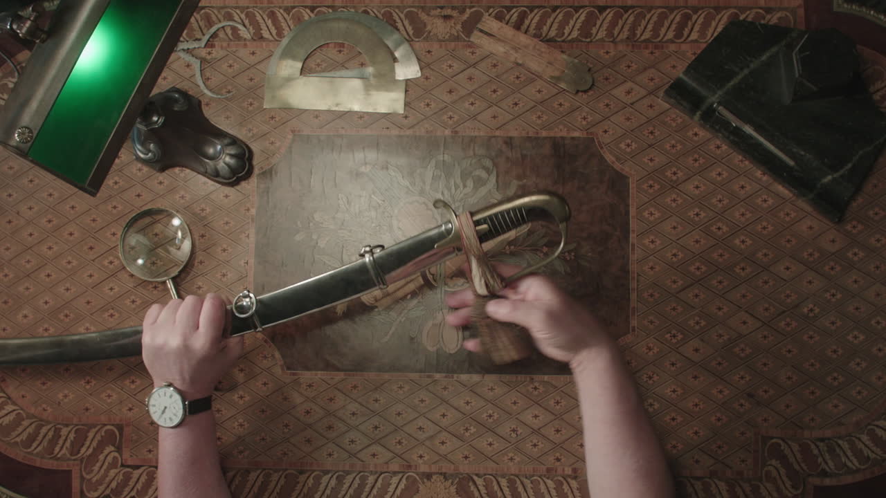 An older man evaluates an old saber