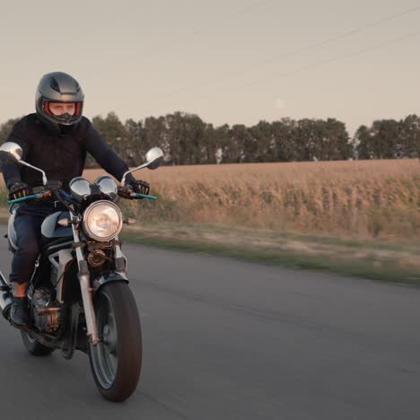 a motorcyclist rides a motorcycle before sunset 1