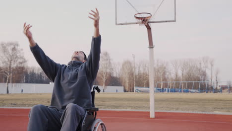 young disabled man playing to basketball with his friend 3