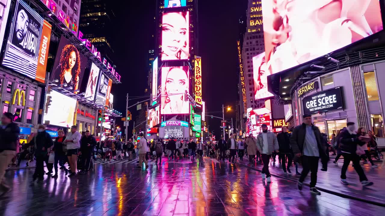 Vibrant cityscape video of Times Square at night, captured from a low angle, showcasing illuminated