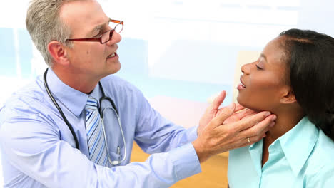 médico chequeando las glándulas de su paciente