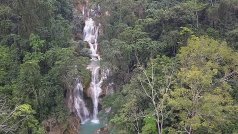 aerial retreats to reveal stunning tiers of kuang si waterfall in laos