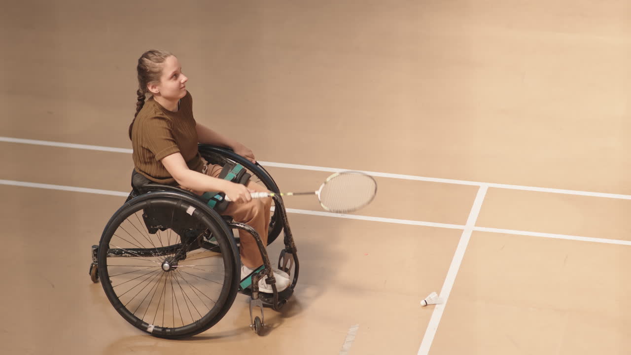 Girl with Disability Hitting Shuttles with Racket