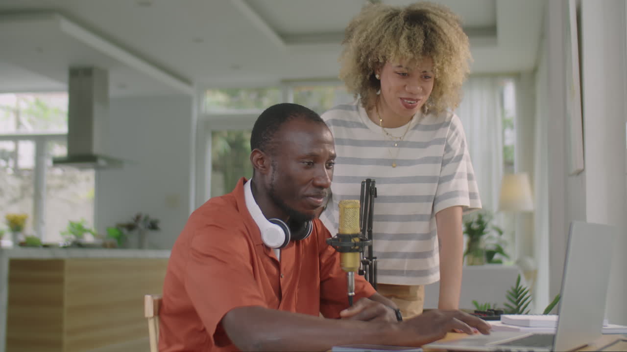 Couple Using Laptop in Home Recording Studio