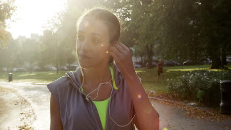 runner woman running in park exercising outdoors fitness tracker wearable technology