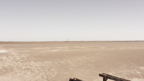 Drone-heading-towards-a-timber-object-at-the-beach