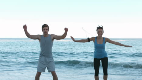 Gente-Atractiva-Haciendo-Ejercicio-En-La-Playa