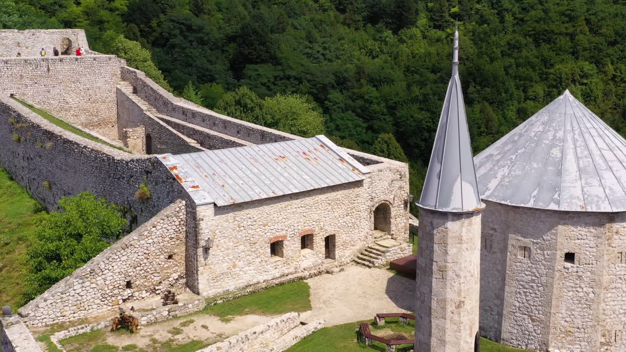 Minaret and main hall building of Travnik Castle in Bosnia and Herzegovina, Aerial dolly out reveal shot