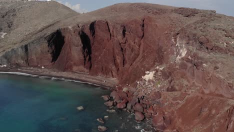 Tourists-explore-Kokkini-Paralia,-Red-Beach-on-Aegean-Santorini