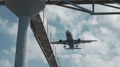 plane descending over the city for final approach