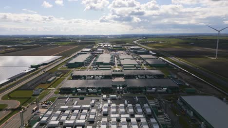drone footage showing the scale and symmetry of a massive data center and energy facility in middenmeer, the netherlands