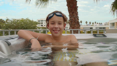 Teenager-enjoying-hot-tub-outdoors