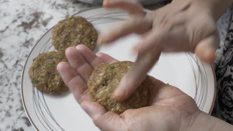 muslim woman making kebab patty using mince meat