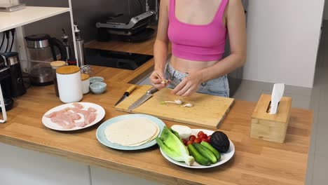 preparing a chicken & veggie tortilla wrap