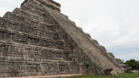 famous temple of kukulcan and the stairs with the heads of the feathered serpents at the base of the stairways at chichen itza