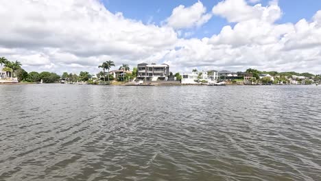 riverside homes under a bright, cloudy sky