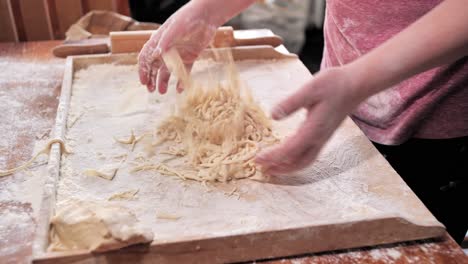 woman, housewife, tosses, lives with the flour, ready noodles to keep them from sticking together