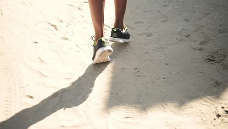 low section of man running on the beach