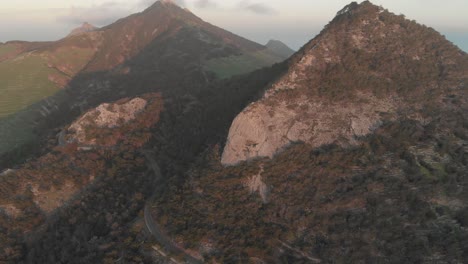 Aerial-forward-tilt-up-reveal-over-mountains-near-Pico-do-Facho,-Portugal