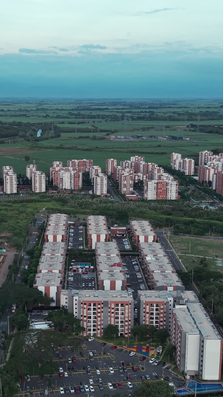 Stunning vertical video capturing an aerial view of Valle del Lili, Cali, featuring urban architecture under soft daylight. Ideal for mobile and social media platforms