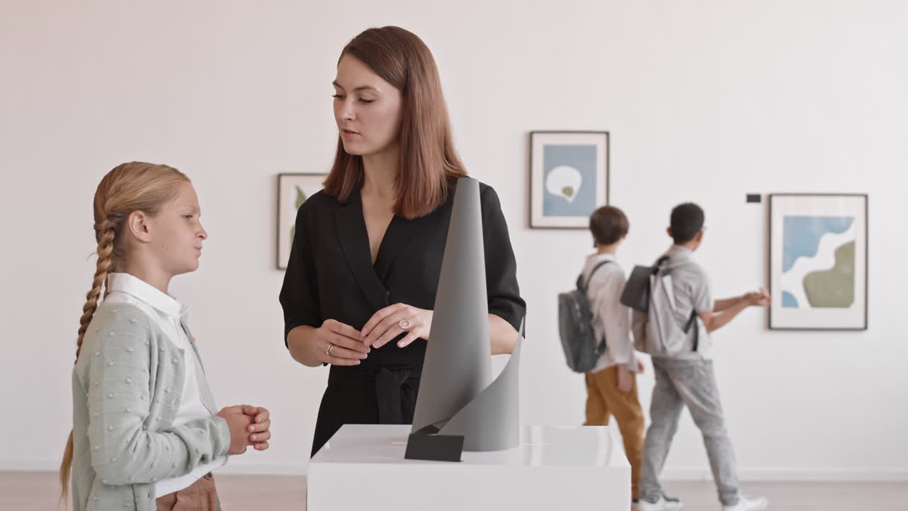 Female Museum Worker Talking to Girl