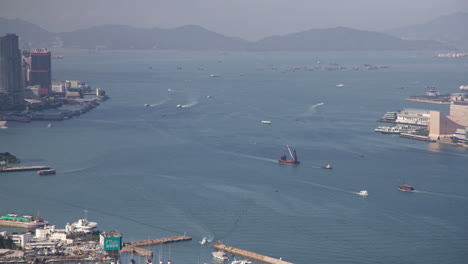 hong kong victoria harbour sea traffic with ferries and cargo ships timelapse in daytime