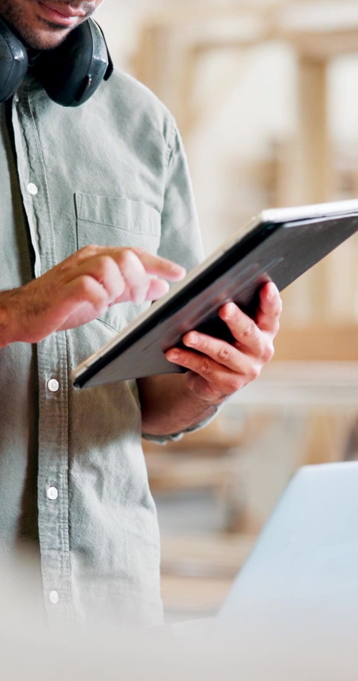 Man Using Digital Tablet in Modern Workspace