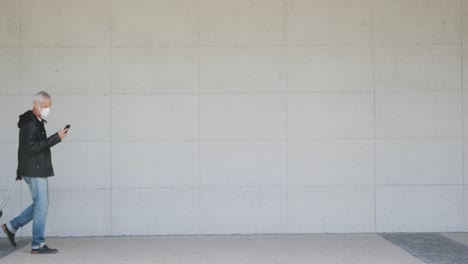 Caucasian-man-out-and-about-in-the-city-street-using-his-smartphone