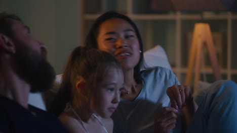 family watching tv at night