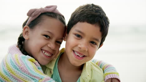 happy siblings hugging on the beach