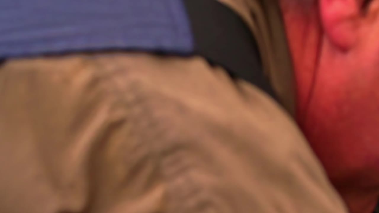 Close-up of a ratchet strap being tightened on a truck to secure the cargo safely