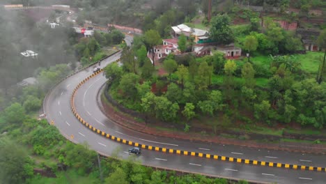 aerial view over curve of four lane e75 expressway on misty foggy day