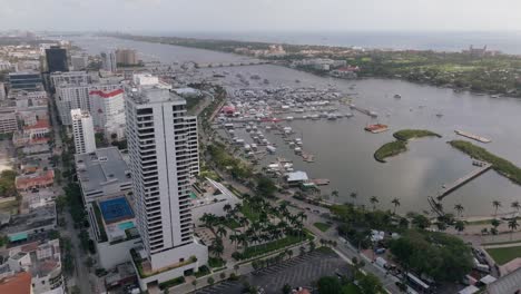 aerial view of a bustling city waterfront with a marina full of yachts