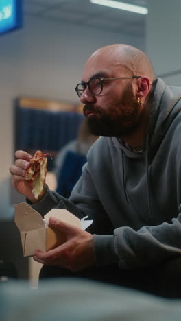 man eating lunch at the airport