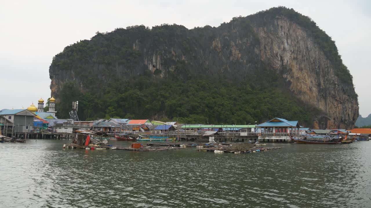 Koh Panyee Fishing Village With Limestone Cliff In The Background In Phang Nga Province, Thailand. Static Shot