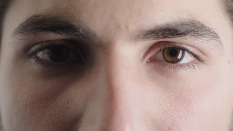 close up man brown eyes opening caucasian male awake looking at camera blinking iris focus macro