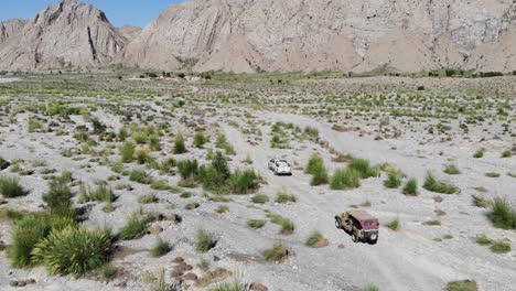 Aerial-shot-of-two-car-driving-in-the-mountains