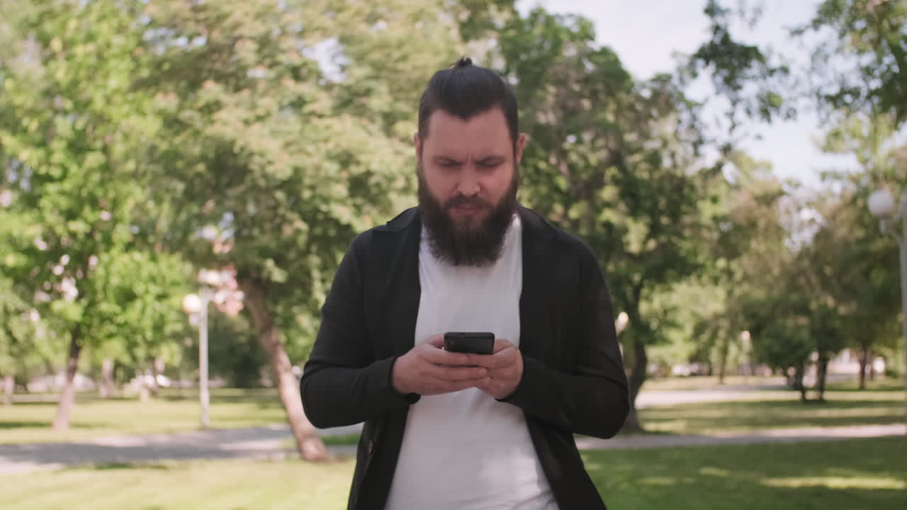 Busy Man with Mobile Phone Walking Outdoors