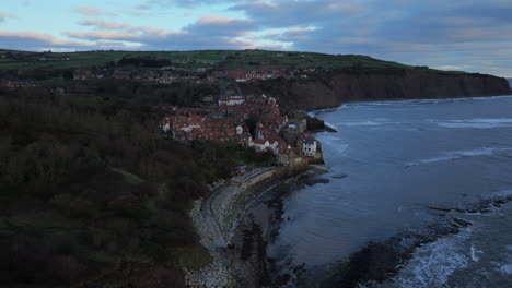establishing drone shot around robin hood's bay on cloudy winter day