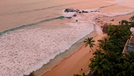 stunning aerial footage capturing the breathtaking weligama coastline bathed in the warm hues of sunset.