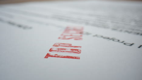 closeup classified paper document with stamp top secret. macro confidential text