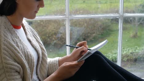 woman sketching on notepad