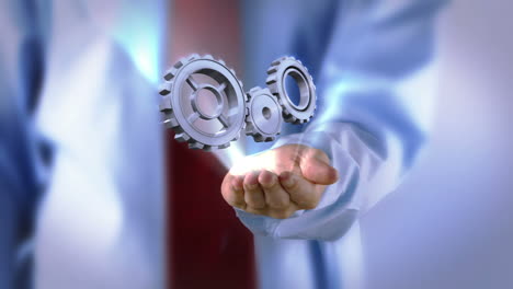 businessman presenting cogs and wheels graphic