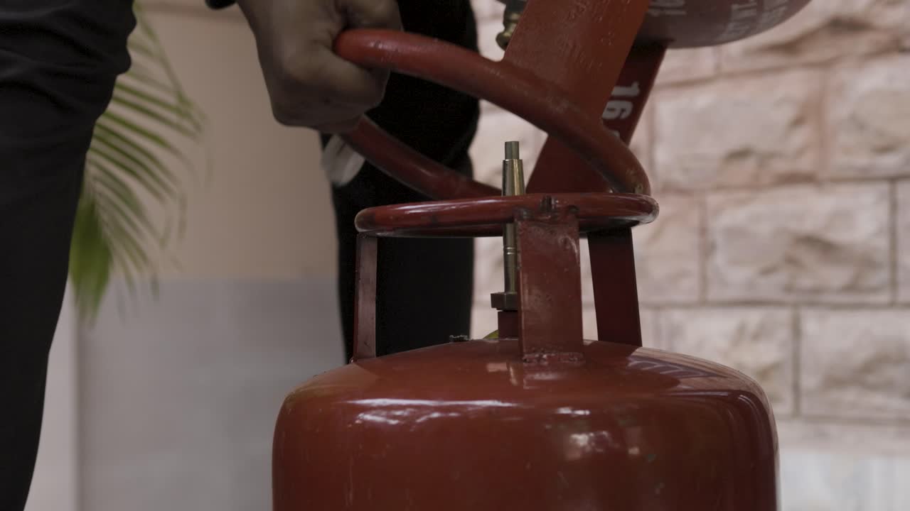 relleno de la botella de gas de petróleo licuado y fuga de gas a través de la válvula cerca durante el día