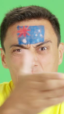 man with australian national flag upset with a referee